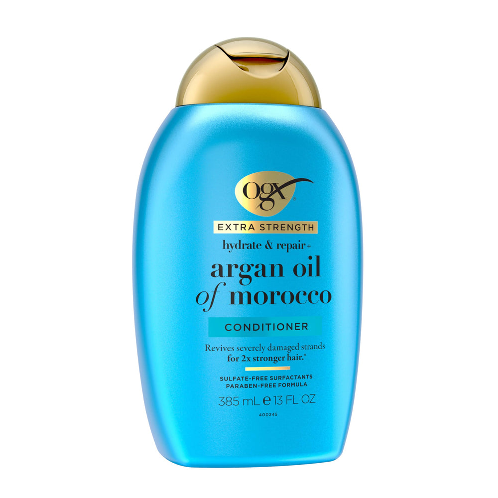 OGX applying conditioner to mid-lengths demonstrating detangling benefit