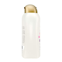OGX shampoo being applied in shower to tame frizz and soften