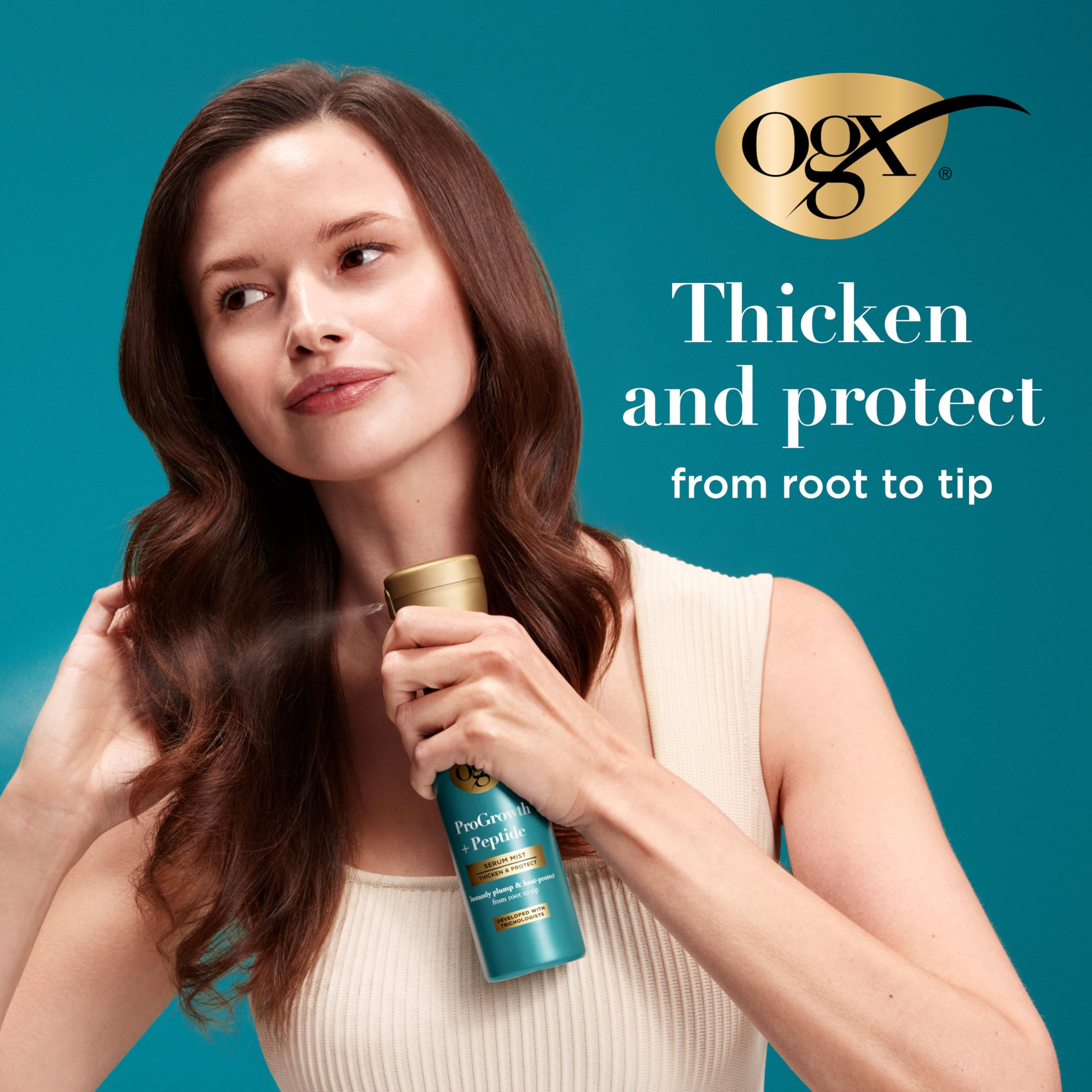 Hand holding OGX bottle to show size and travel-friendly 6.5 fl oz convenience
