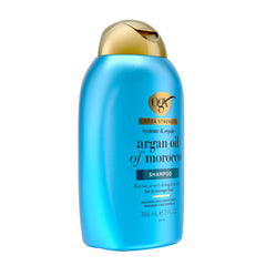 OGX bottle held in hand to show 13 fl oz scale and portability