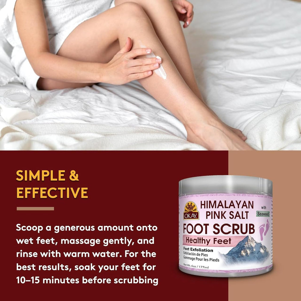OKAY applying scrub to heel demonstrating gentle massage and softer-feet benefit