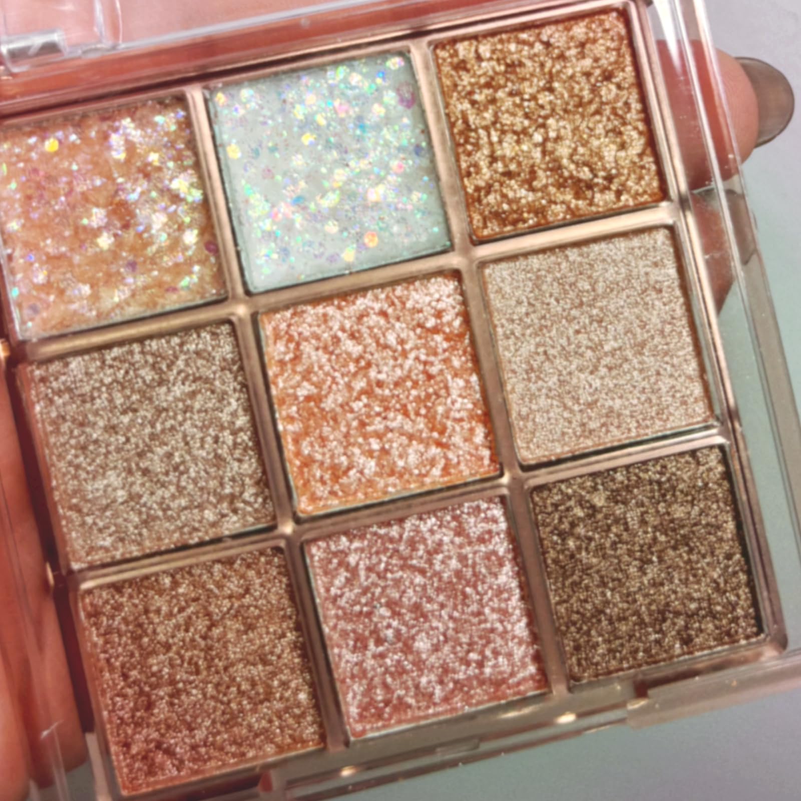 Okerker palette front view showing nine glitter shades and compact design benefit portability