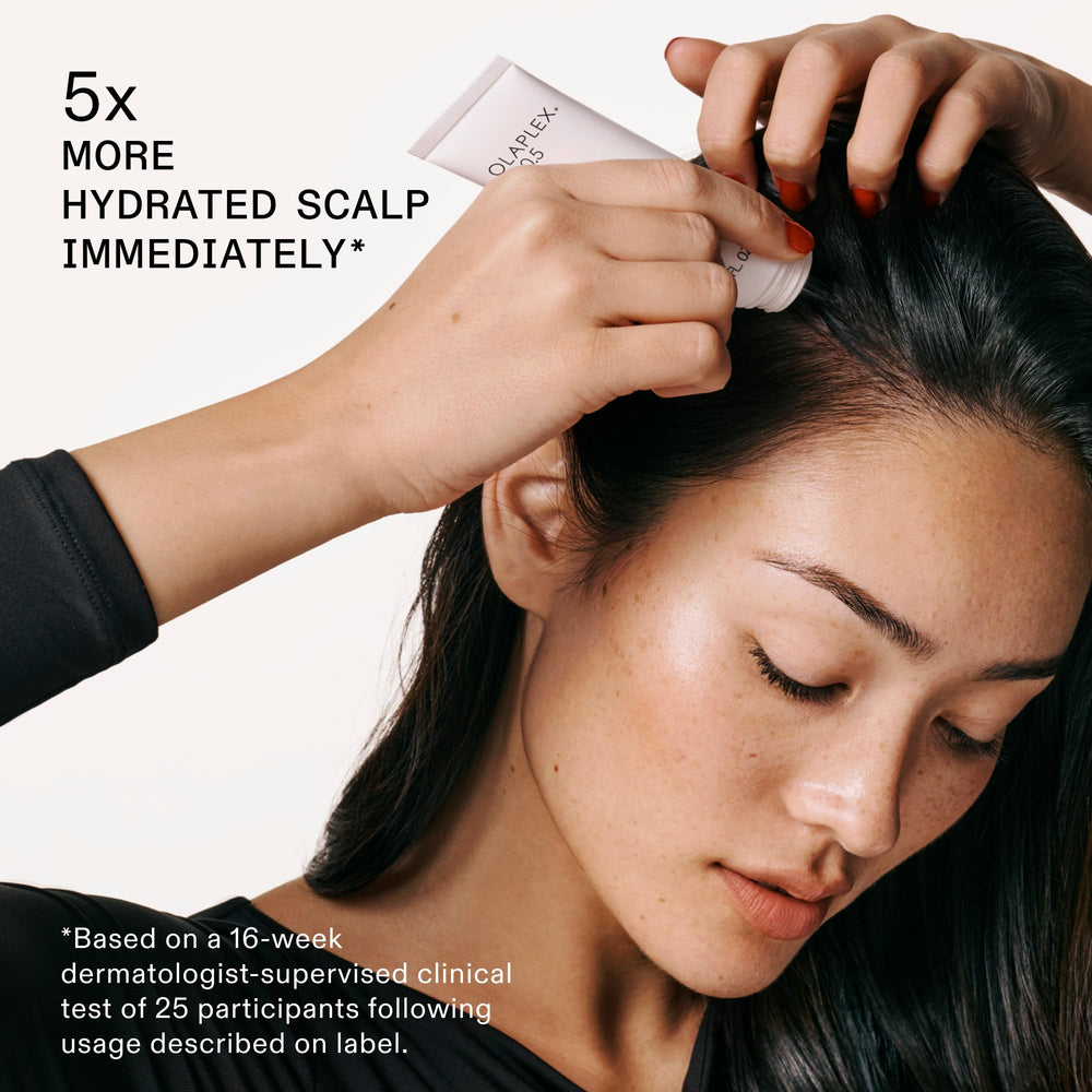 Olaplex conditioner being applied to mid-lengths illustrating detangling and weightless hydration