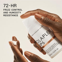 Olaplex N°7 bottle with glossy hair illustrating added shine