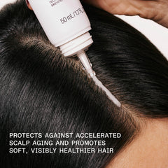 Applying Olaplex Nº.0.5 to scalp with fingertips showing targeted hydration and soothing effect