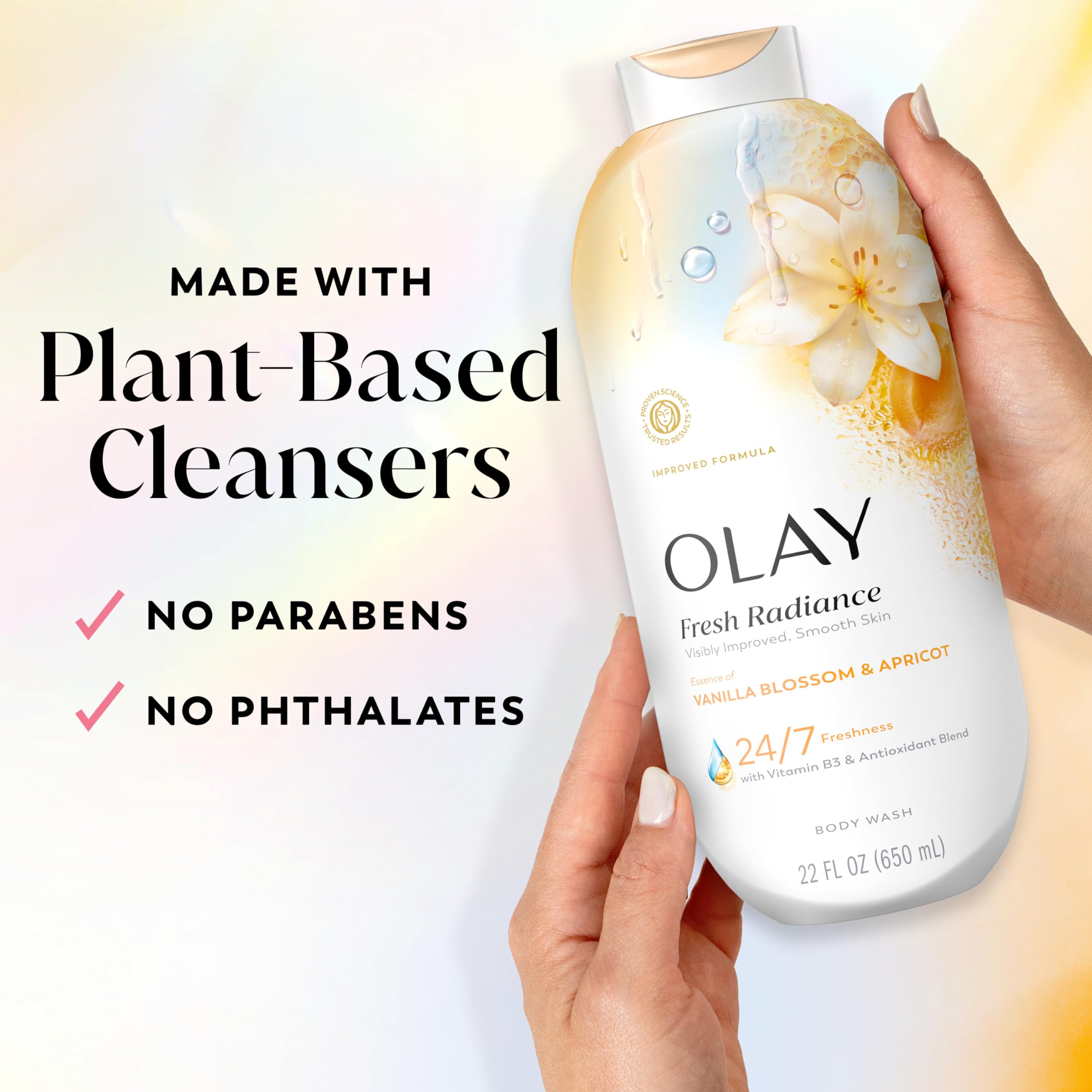 Olay bottle beside common water bottle for scale, shows generous 22 fl oz size