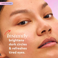 Applying Olay serum to under eye with ring finger, demonstrates gentle application