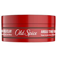 Man in barbershop styling hair using Old Spice clay demonstrating professional results