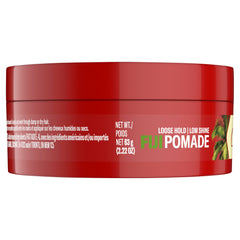 Lifestyle scene with Old Spice Fiji pomade and tropical props suggesting coconut-wood scent