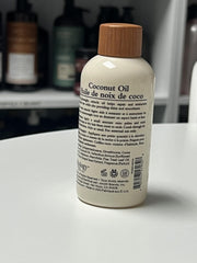 applying Oliology oil to mid-lengths to tame frizz and add shine