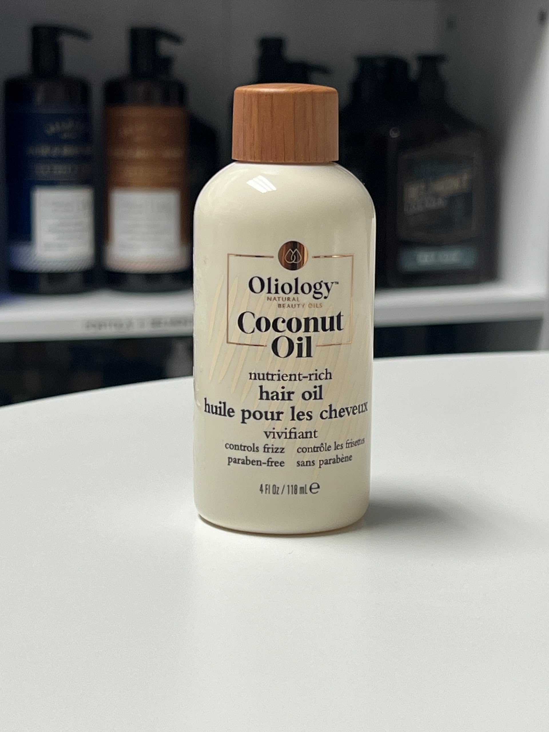 drop of Oliology oil on hand showing lightweight texture and absorption