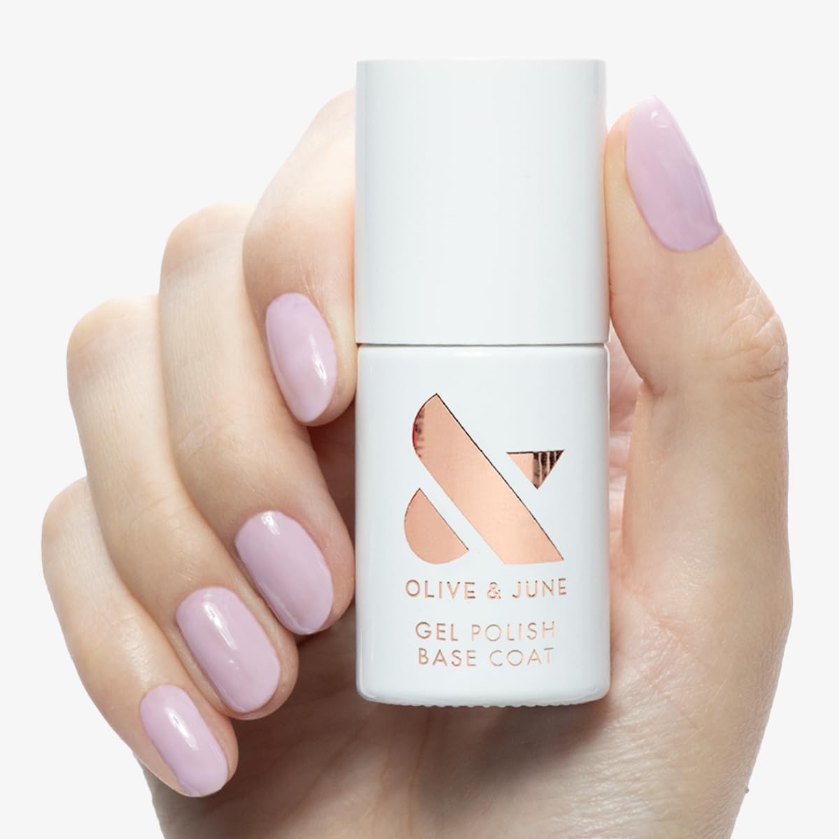 Olive & June brush applying base coat for smooth application benefit