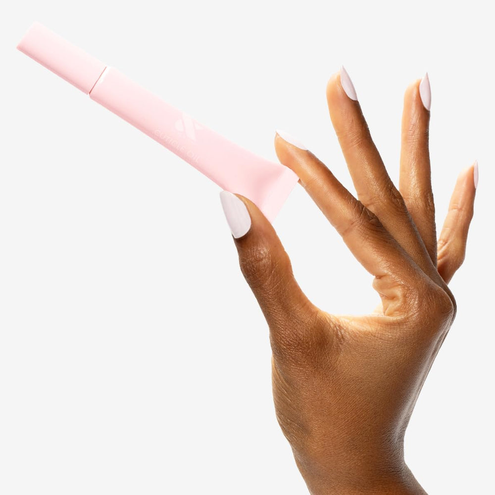 Olive & June application on finger showing controlled brush sweep to moisturize cuticles