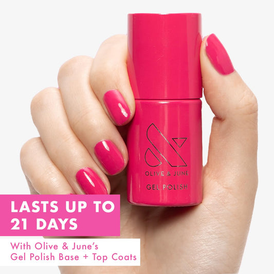 Olive & June open bottle with brush applying XOXO Hot Pink for smooth coverage