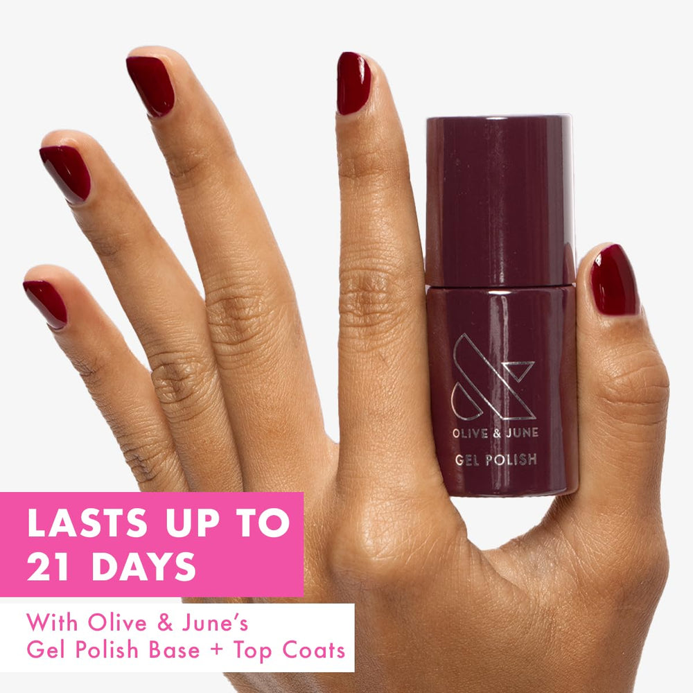 Olive & June brush applying Obsessed Dark Ruby showing smooth application benefit