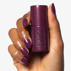 Olive & June bottle held by hand to show size and easy-at-home use benefit