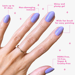 Olive & June top coat applied on manicured hands showcasing chip-resistant shine