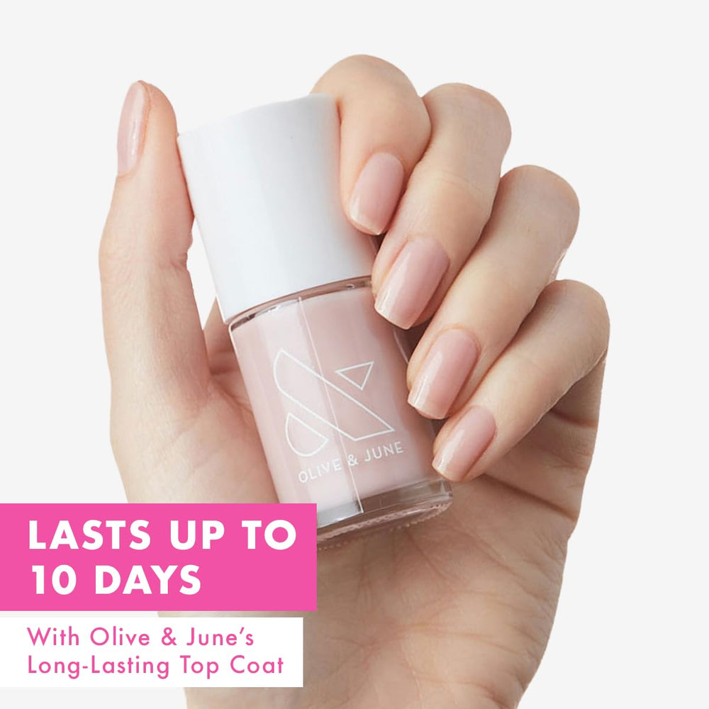 Olive & June wide brush fanning across nail for smoother application benefit