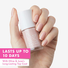 Olive & June wide brush fanning across nail for smoother application benefit