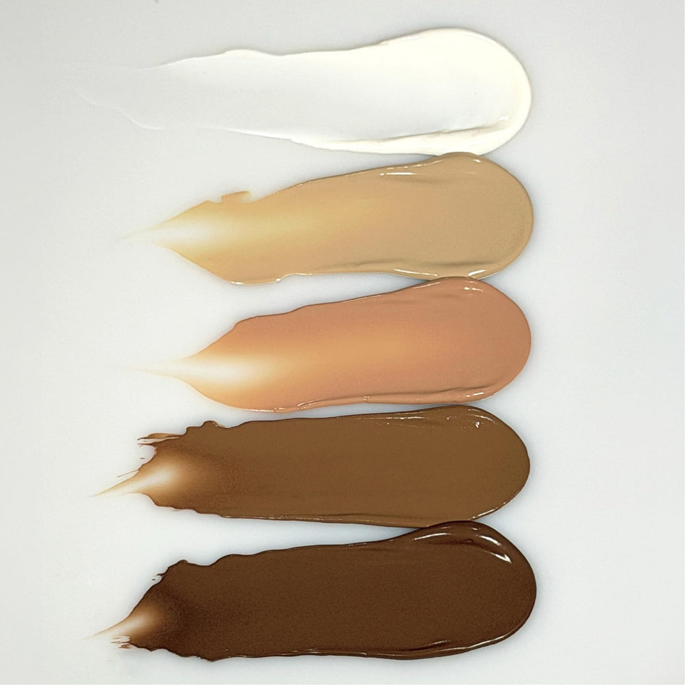 OneSkin tinted swatch on forearm showing seamless coverage and finish