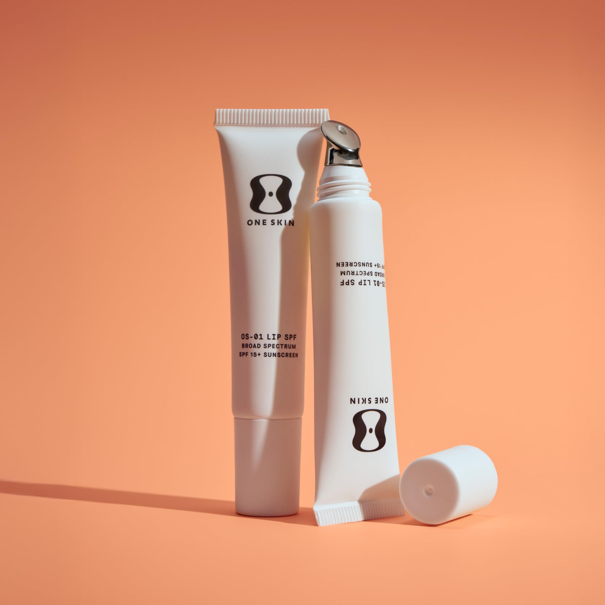 oneskin lip spf applied on fingertips demonstrating glide benefit: easy reapplication on the go