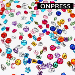 ONPRESS open compartment grid with 48 wells showing sorted colorful nail rhinestones