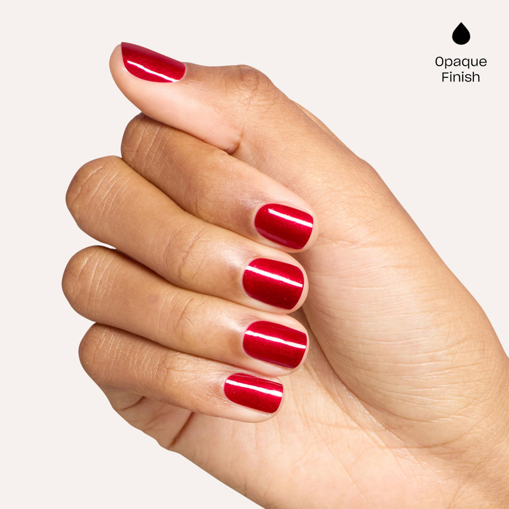 OPI Battle Red-y bottle in hand for scale and easy-at-home manicure advantage