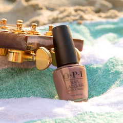 OPI bottle beside a coin to demonstrate size and travel-friendly benefit