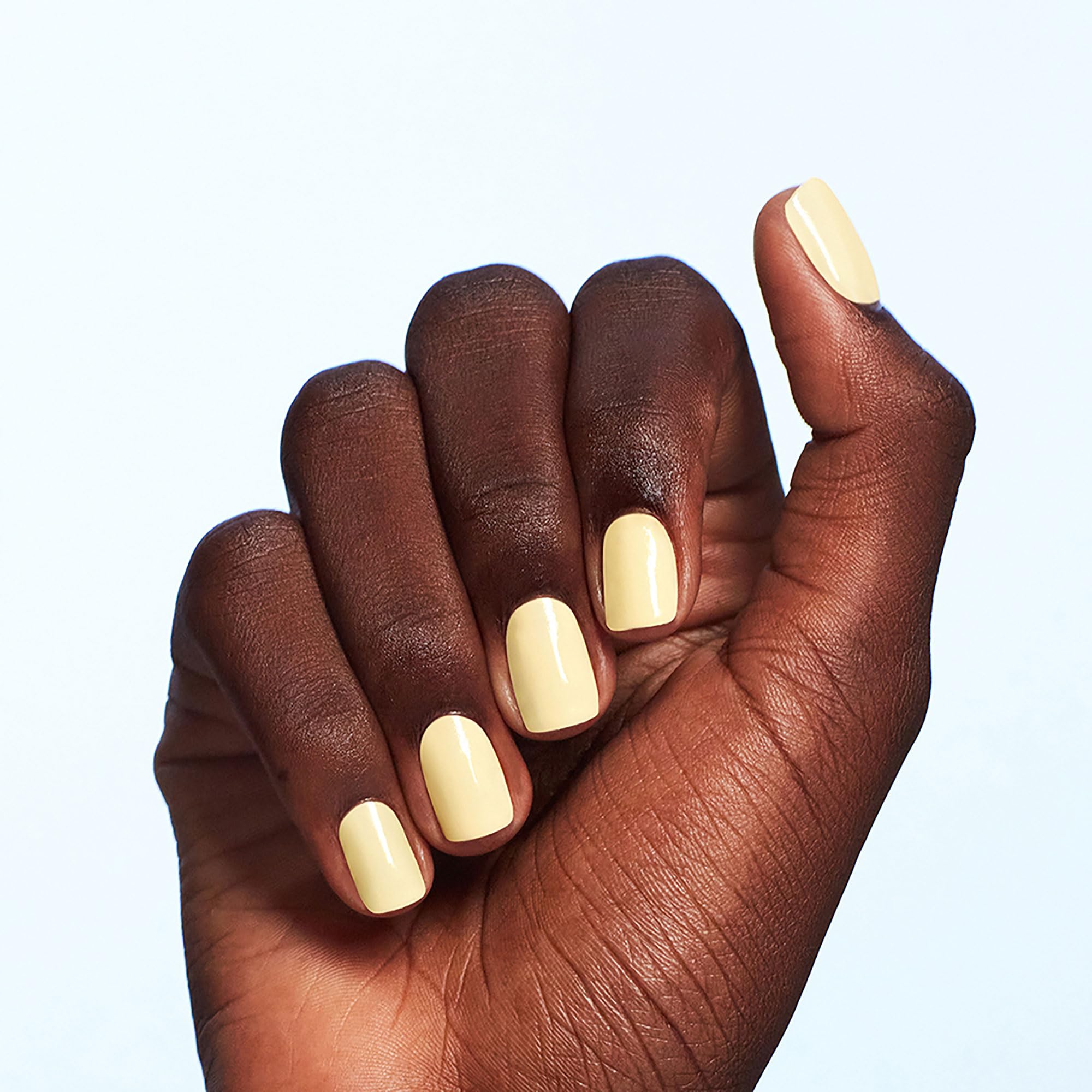 OPI bottle placed on hand showing polished nails and wearable color
