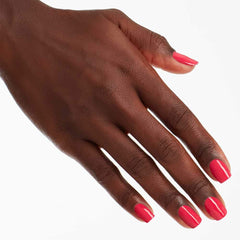 Hand holding OPI Charged Up Cherry bottle demonstrating easy application and salon look benefit