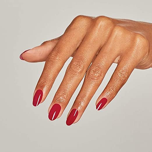 Hands applying OPI red polish demonstrating salon-like finish