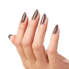 Hand model wearing OPI espresso brown polish showcasing polished manicure