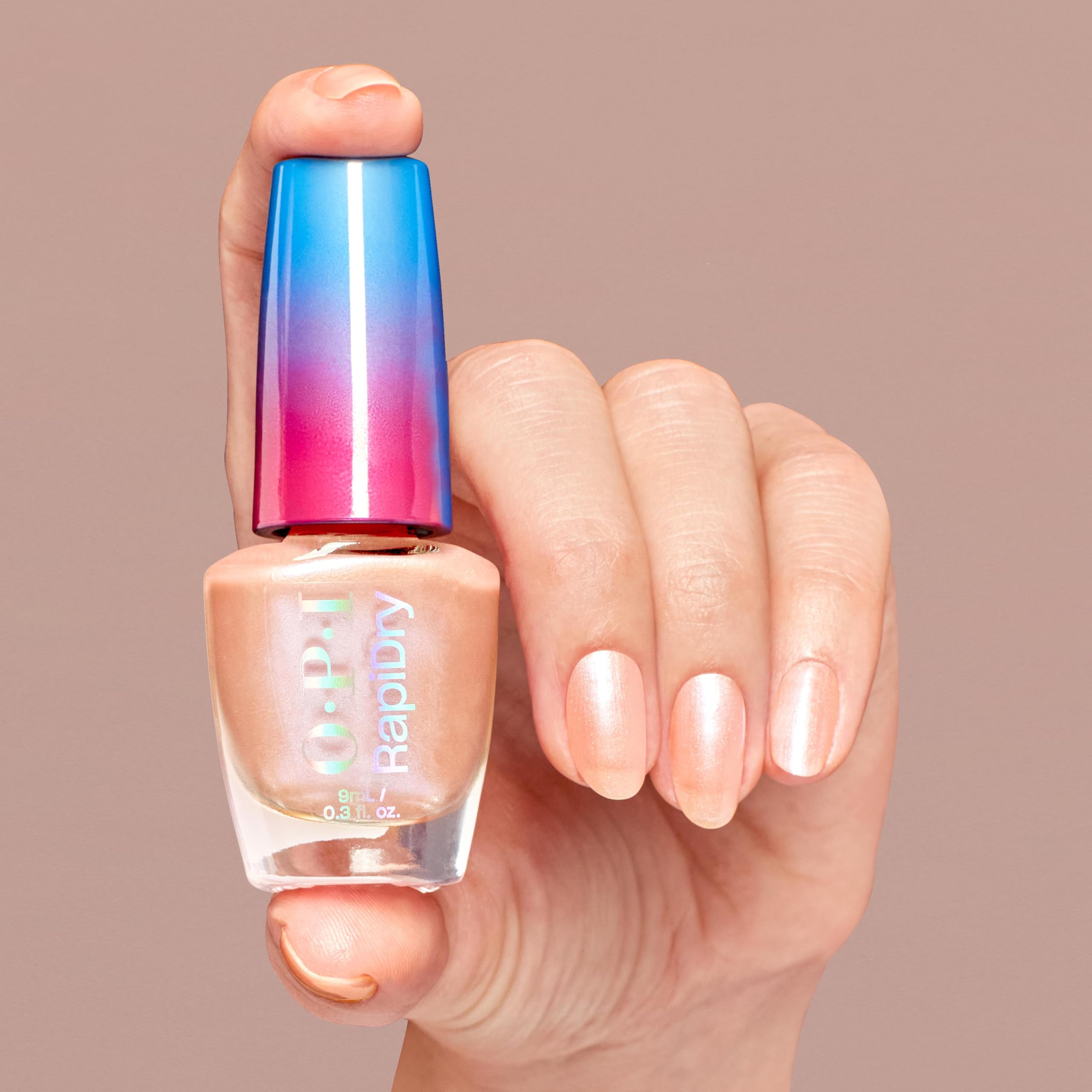 OPI on manicured nails in lifestyle shot showing fast-dry, smudge-resistant soft peach pearl benefit