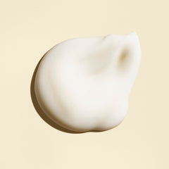 Oribe Balm D'Or 3.4 oz next to common objects showing compact travel-friendly size
