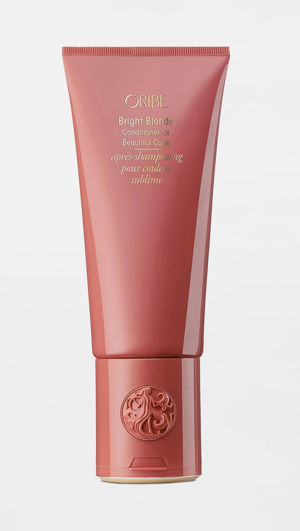 Oribe bright blonde conditioner next to towel in bathroom, demonstrates at-home salon care