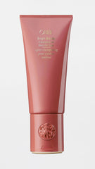 Oribe bright blonde conditioner next to towel in bathroom, demonstrates at-home salon care