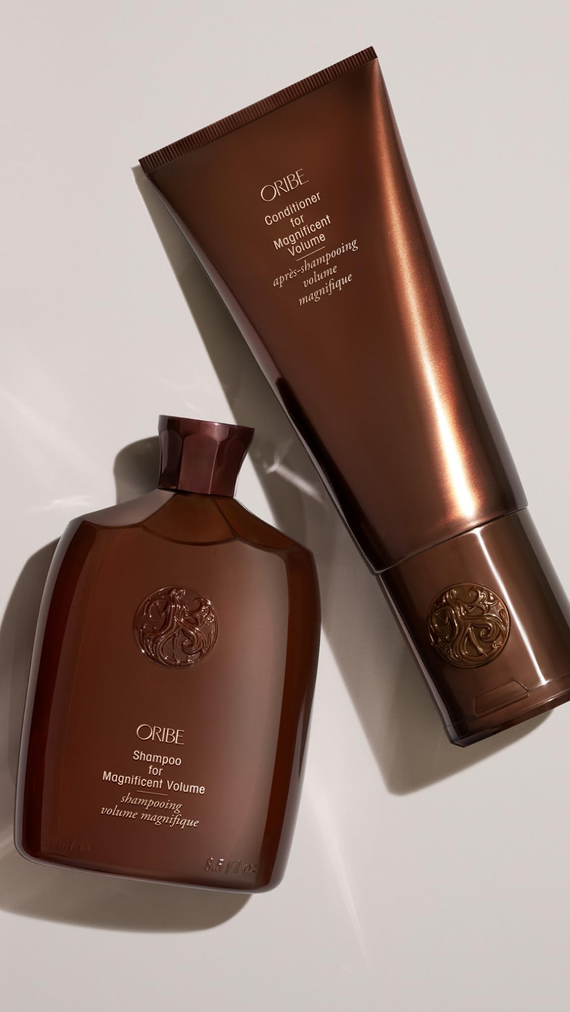 Oribe conditioner being applied to damp hair for easier combing benefit