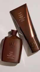 Oribe conditioner being applied to damp hair for easier combing benefit