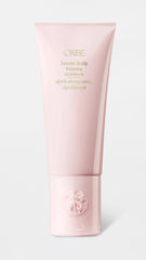 Oribe conditioner pump detail emphasizing easy dispensing and travel-friendly cap