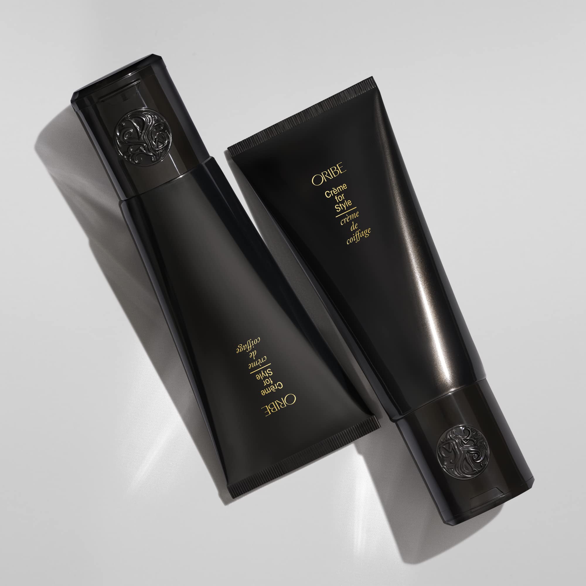 Oribe 5 oz jar next to common objects to show scale and portability