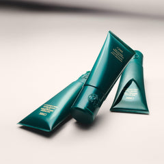 Oribe Curl Control cream spread on fingers highlights smooth application benefit