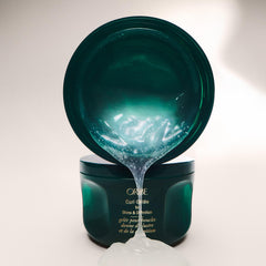 Oribe curl gel on hair being diffused showing voluminous, high-shine results benefit