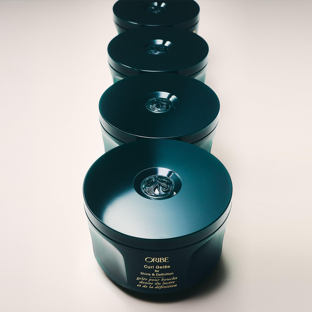 Oribe curl gel applied to damp curls illustrating defined, frizz-controlled finish benefit