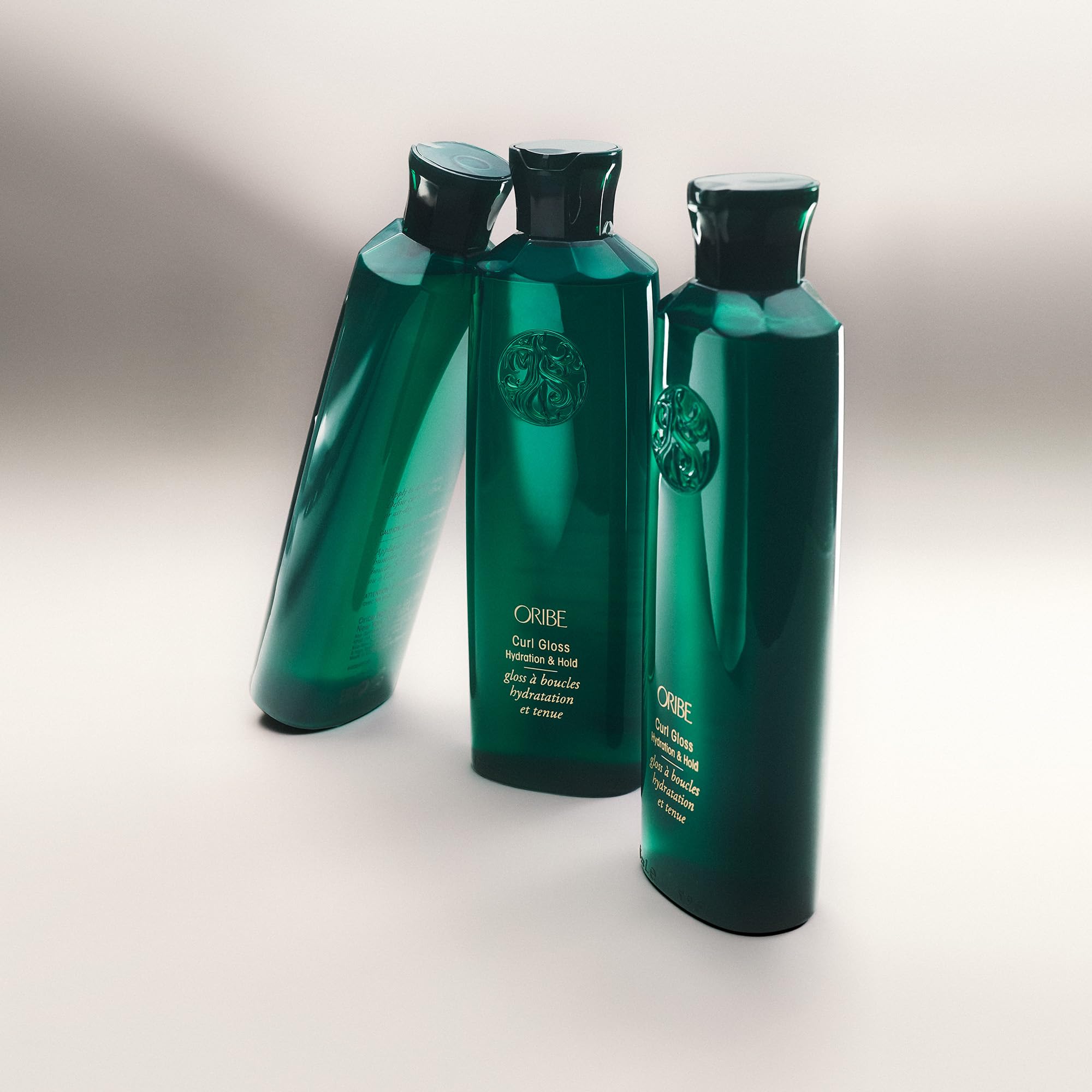 Oribe bottle held to show 5.9 fl oz scale and travel-friendly benefit