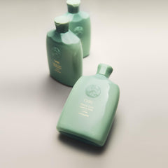 Oribe Eternal Curls in hand during application showing gentle cleanse benefit