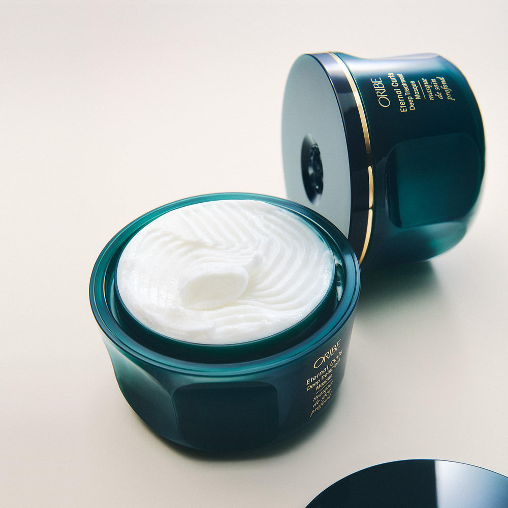 Oribe Eternal Curls jar held in hand showing 8.5oz scale benefit