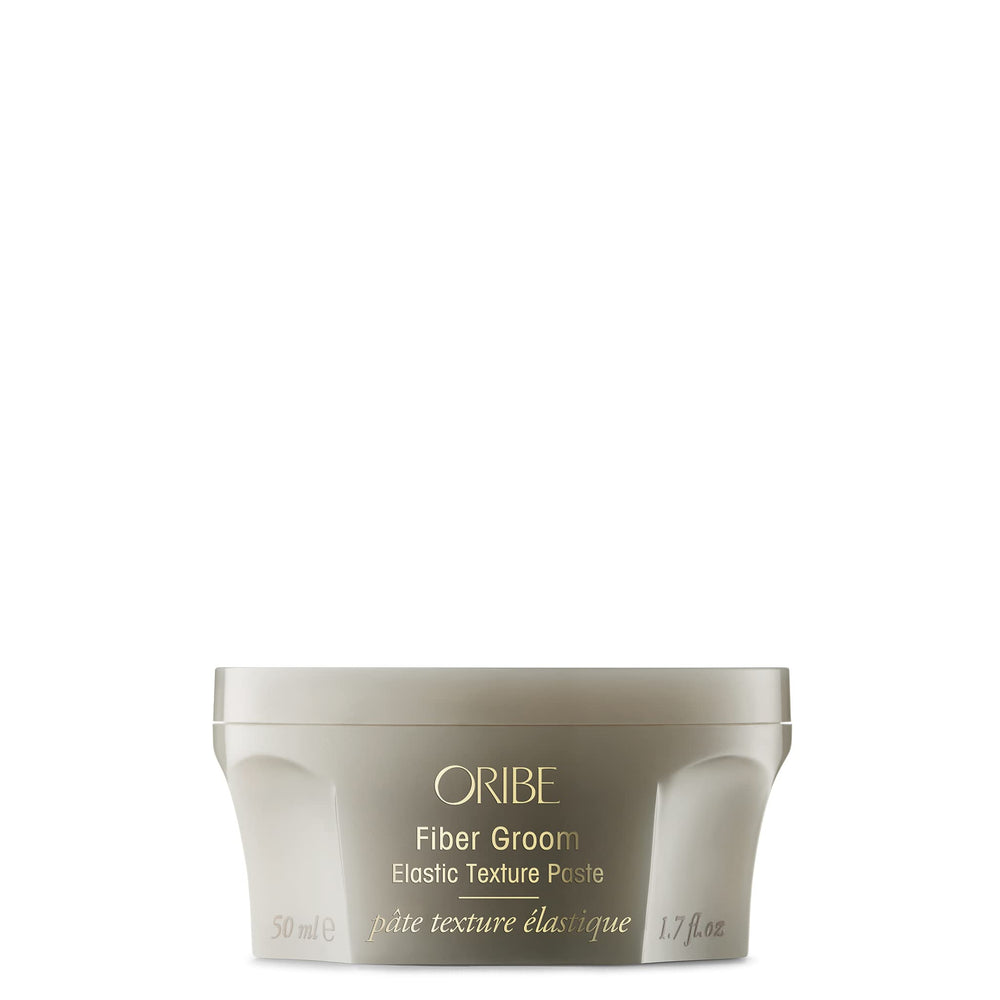 Oribe Fiber Groom front jar view showing sleek label and compact size for travel