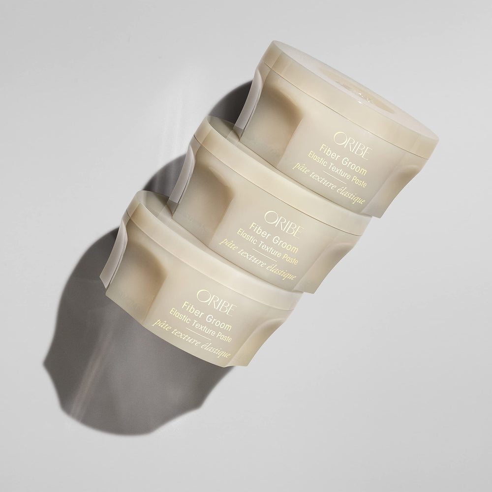 Close-up of Oribe Fiber Groom paste texture highlighting fibrous, pliable formula