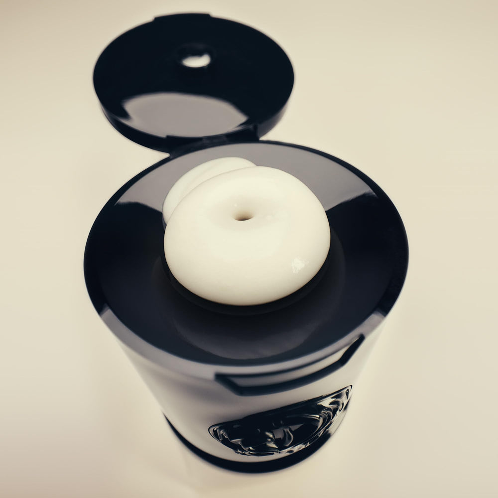 Oribe Gold Lust conditioner on bathroom vanity evoking luxury grooming routine
