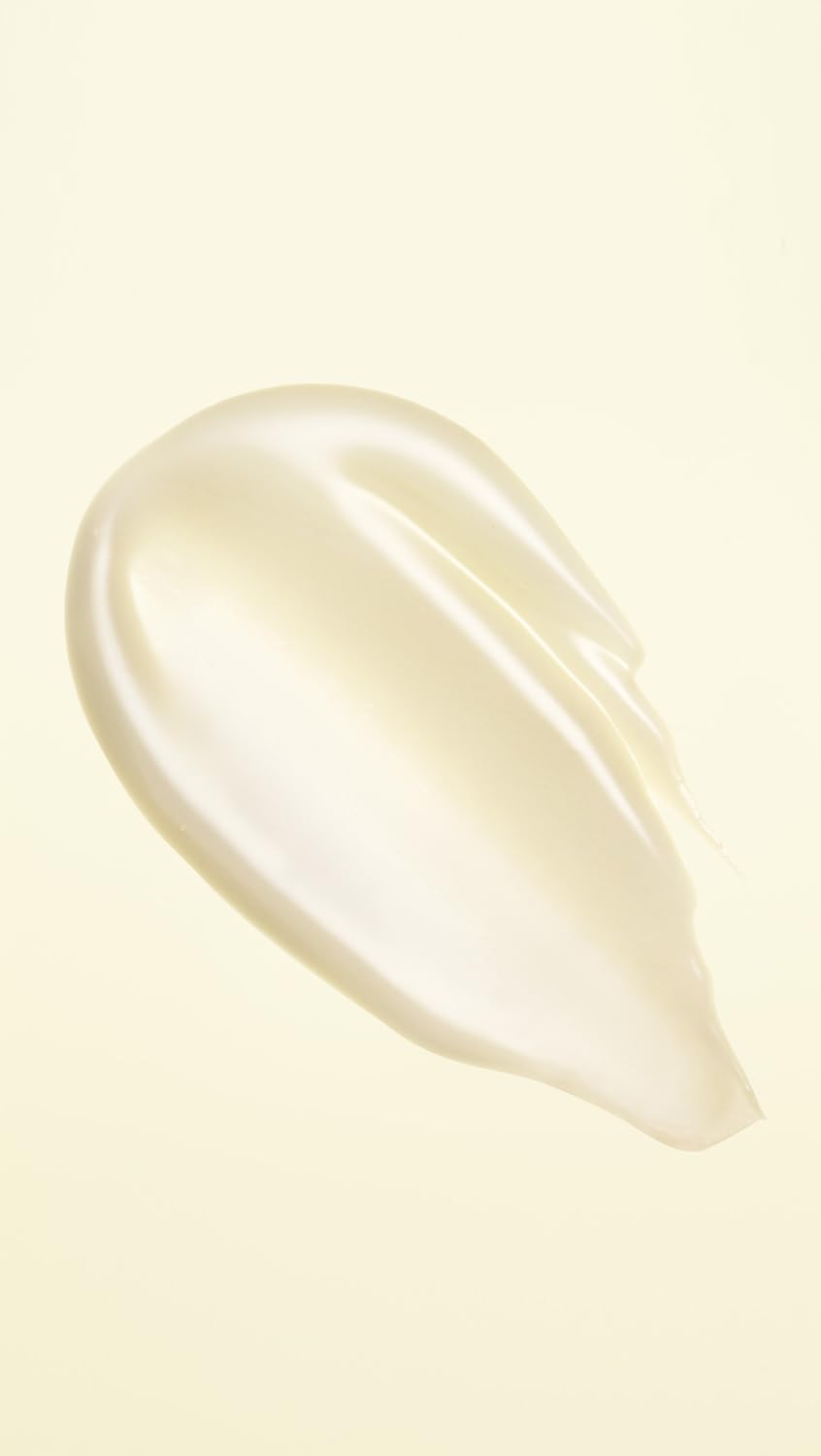 Oribe creamy conditioner texture on palm for visible hydration benefit